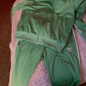 Neon green Adidas track suit with white stripes down the sides.